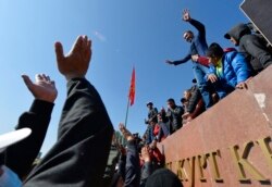 FILE - People protest during a rally on the central square in Bishkek, Kyrgyzstan, Oct. 7, 2020. Officials in Kyrgyzstan have nullified the results of parliamentary elections after mass protests erupted in Bishkek and other cities.