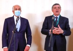 Russia's special representative on Afghanistan Zamir Kabulov, right, and U.S. special envoy Zalmay Khalilzad attend a news briefing following an Afghan peace conference in Moscow, Russia, March 18, 2021.