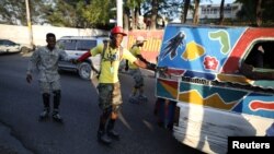 Ti moun kap woule paten nan lari Potoprens. Foto: REUTERS/Andres Martinez Casares , 18 mas 2018. 