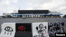 A road block with graffiti is seen at the Lekki toll gate, site of protests that turned deadly when security forces opened fire on demonstrators earlier this week, in Lagos, Nigeria, Oct. 24, 2020. 