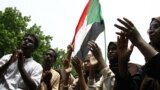 Scores of students of a Khartoum-based university celebrate after an agreement was reached between protest leaders and members of the Transitional Military Council in the Sudanese capital, July 17, 2019. 