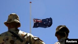 FILE - Australian troops stand at attention during a ceremony at Camp Armadillo in Afghanistan's in Helmand province, April 25, 2008. 