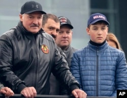 FILE - Belarusian President Alexander Lukashenko, left, and his sons Viktor, second from left, Dmitry, third from left, and Nikolai, right, attend a meeting in Minsk on Sept. 24, 2016. Lukashenko has kept Nikolai at his side at official events.