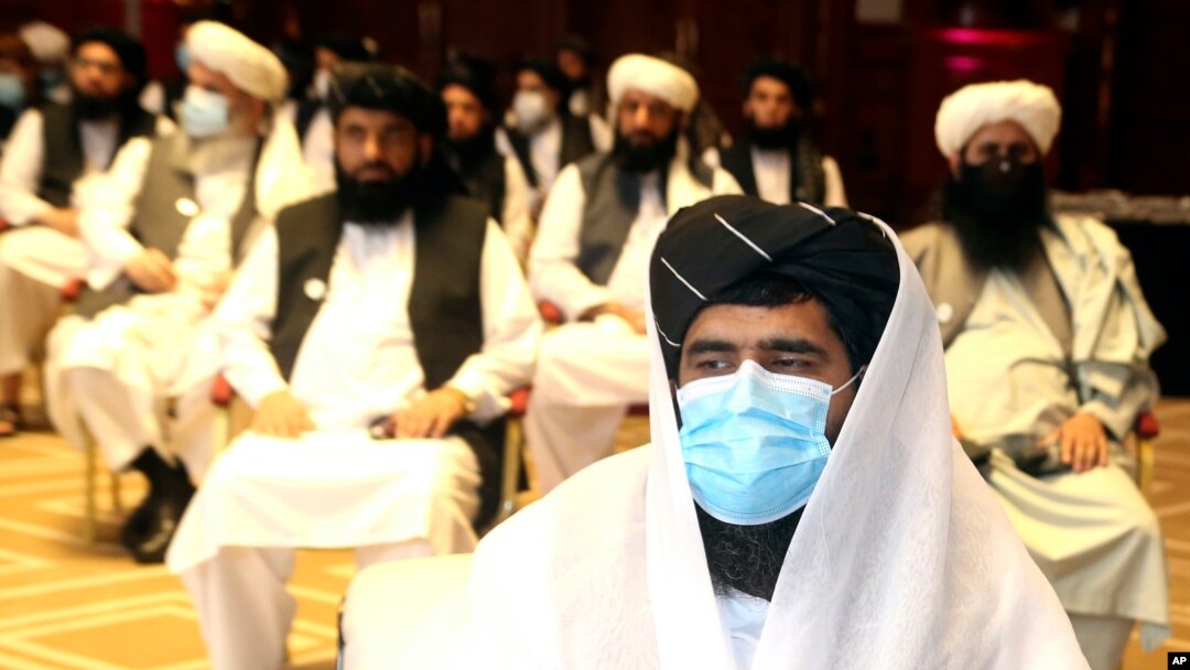 FILE - A member of Taliban negotiation delegation keeps his face mask on during the opening session of the peace talks between the Afghan government and the Taliban in Doha, Qatar, Sept. 12, 2020. The talks have achieved no breakthroughs. 