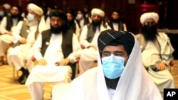 FILE - A member of Taliban negotiation delegation keeps his face mask on during the opening session of the peace talks between the Afghan government and the Taliban in Doha, Qatar, Sept. 12, 2020. The talks have achieved no breakthroughs. 