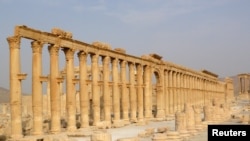 FILE - The demolition of ancient monuments like this colonnade in the historical city of Palmyra, Syria was targeted by the Islamic State group and among cultural sites destroyed in 2015. 