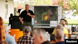 El Dorado Sheriff Lt. Jeff Leikauf briefs residents at a Caldor Fire evacuation shelter at Green Valley Community Church, in Placerville, Calif., Aug. 21, 2021. 