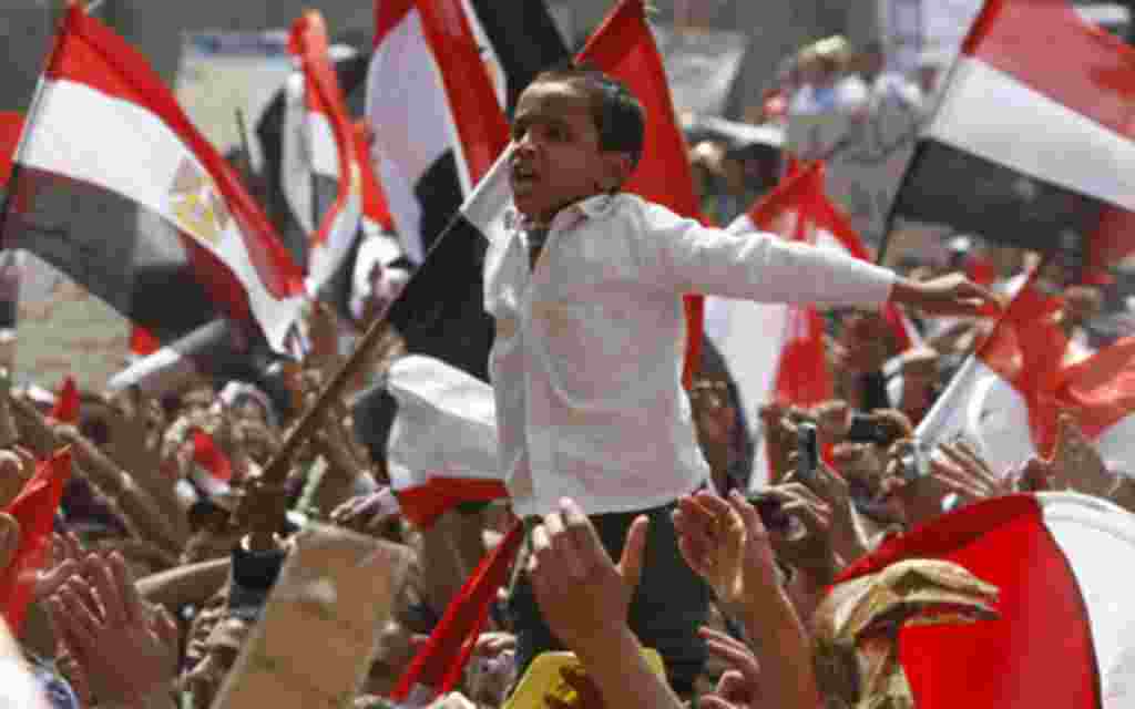 A young Egyptian protester shouts slogans at Tahrir Square in Cairo April 1, 2011. Thousands of demonstrators gathered in Tahrir Square calling for the demands of the revolution that toppled former president Hosni Mubarak from power to be met. REUTERS/Amr