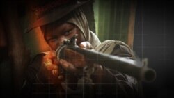 A woman holds up a sign for the media against the window at the Radisson Blu Edwardian Hotel, near London's Heathrow Airport, where passengers will remain during a 10-day quarantine period after arriving in England at the airport.