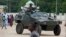Nigerian soldiers ride on an armored personnel carrier during Eid al-Fitr celebrations in an area of Nigeria where an Islamic insurgency is raging, in Maiduguri, Nigeria, Aug. 8, 2013.