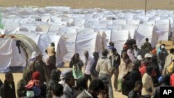 Migrant workers who used to work in Libya and fled the recent unrest in the country, are seen in a refugee camp at the Tunisia-Libyan border, in Ras Ajdir, Tunisia, March 9, 2011,. (AP Image)