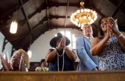 FILE - Parishioners clap during a worship service at the First Baptist Church, a predominantly African-American congregation, in Macon, Ga., July 10, 2016.