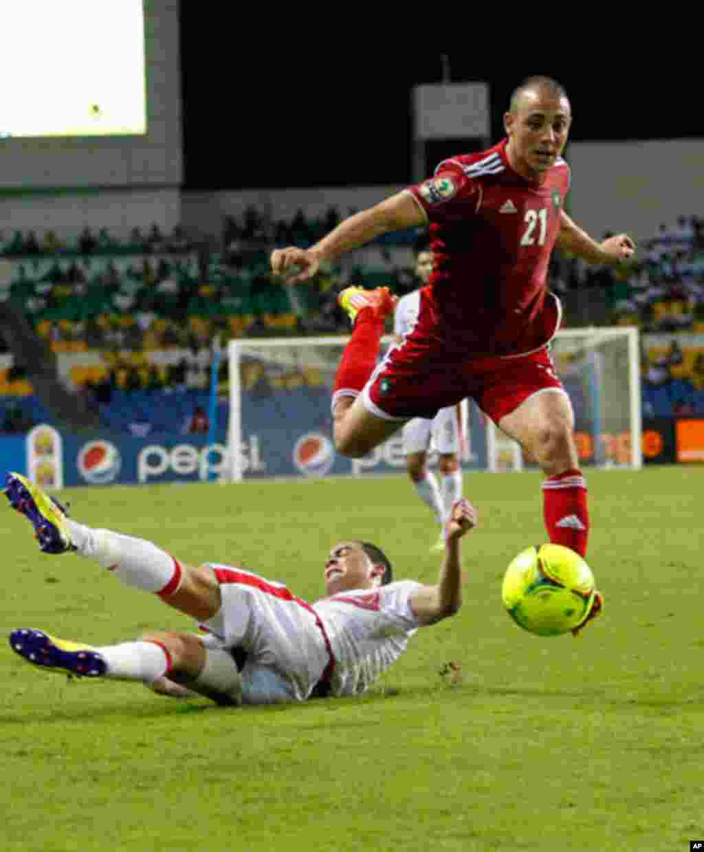 Morocco's Noureddine drives the ball over Tunisia's Ammar during their African Cup of Nations soccer match in Libreville