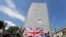 Members of far-right Football Lads Alliance hold a British flag in front of a protective covering surrounding the statue of former British Prime Minister Sir Winston Churchill in Parliament Square, central London, June 13, 2020.