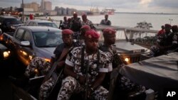 FILE - Ivory Coast troops provide security during an election rally of Ivory Coast incumbent President Alassane Ouattara in Abidjan, Ivory Coast. 