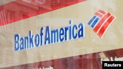 FILE - A customer uses an ATM at a Bank of America branch in Boston, Massachusetts, U.S.