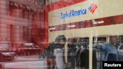 FILE - A customer uses an ATM at a Bank of America branch in Boston, Massachusetts, U.S.