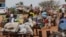 FILE - Chadian cart owners transport belongings of Sudanese people who fled the conflict in Sudan's Darfur region, while crossing the border between Sudan and Chad in Adre, Chad, on Aug. 4, 2023.