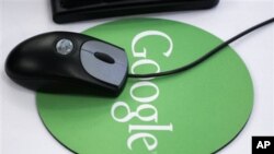 In this Oct. 2006 file photo, a mouse sits atop a Google mouse pad at Google's New York office.