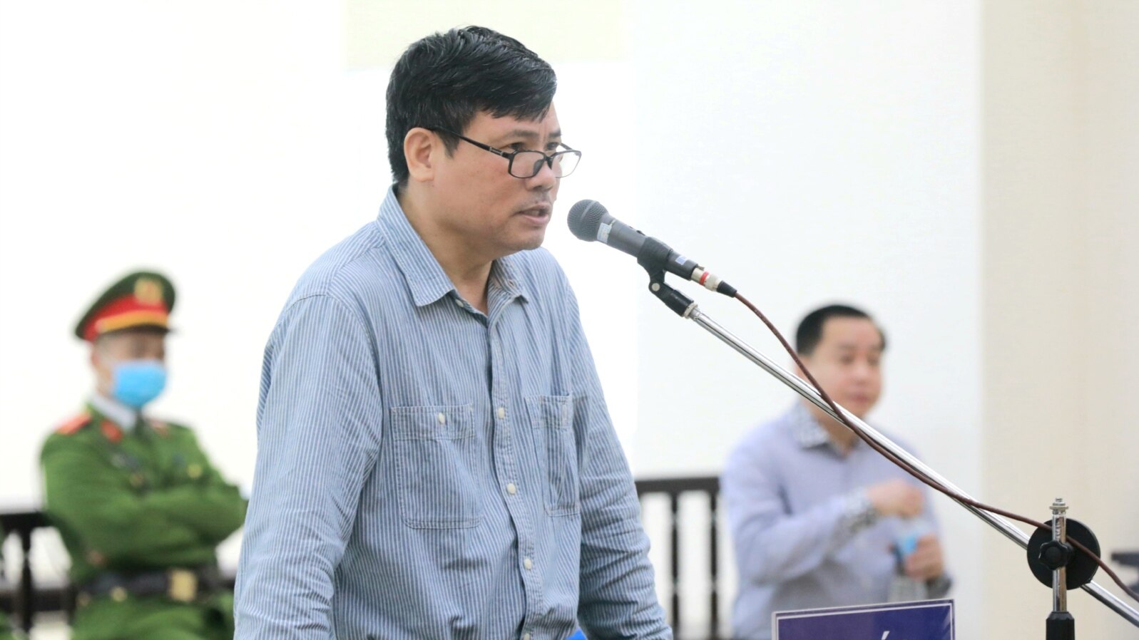 Blogger and former journalist Truong Duy Nhat is seen during his trial at a court in Hanoi, March 9, 2020. 