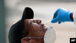 Leandro Moya Lara, who is homeless, is tested for COVID-19 in a program administered by the Miami-Dade County Homeless Trust, during the new coronavirus pandemic, April 16, 2020, in Miami. 