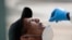 Leandro Moya Lara, who is homeless, is tested for COVID-19 in a program administered by the Miami-Dade County Homeless Trust, during the new coronavirus pandemic, April 16, 2020, in Miami. 
