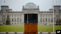 An oversized urn placed by the artist group 'Center for Political Beauty" in front of German parliament building, the Reichstag, in Berlin, Germany, Dec. 2, 2019.