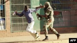 FILE: A Zimbabwean soldier beats a man in a street of Harare on August 1, 2018 as protests erupted over alleged fraud in the country's election. (AFP)