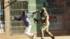 FILE: A Zimbabwean soldier beats a man in a street of Harare on August 1, 2018 as protests erupted over alleged fraud in the country's election.