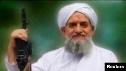 FILE PHOTO: A photo of Al Qaeda leader Ayman al-Zawahiri is seen in this still image taken from a video