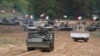 FILE - Military vehicles and tanks of Poland, Italy, Canada and the US participate in NATO military exercises in Kadaga, Latvia, Sept. 13, 2021.