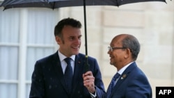 FILE - France's President Emmanuel Macron, left, welcomes Haiti's Presidential Council President Leslie Voltaire before a meeting at The Elysee Palace in Paris on Jan. 29, 2025. 