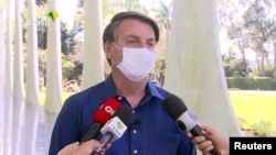 Brazil's President Jair Bolsonaro confirms positive coronavirus diagnosis as he speaks to the media in Brasilia, Brazil, July 7, 2020 in this still image taken from video.