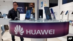 Huawei's mobile phones are displayed at a telecoms service shop in Hong Kong, March 29, 2019. 