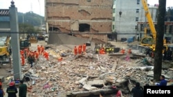 Rescue workers search the site where three five-story residential buildings collapsed in Wenzhou, Zhejiang province, China, Feb. 2, 2017