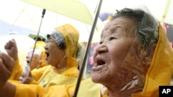 FILE - Former comfort women who served the Japanese Army as sexual slaves during World War II, at a rally before Korean Liberation Day.