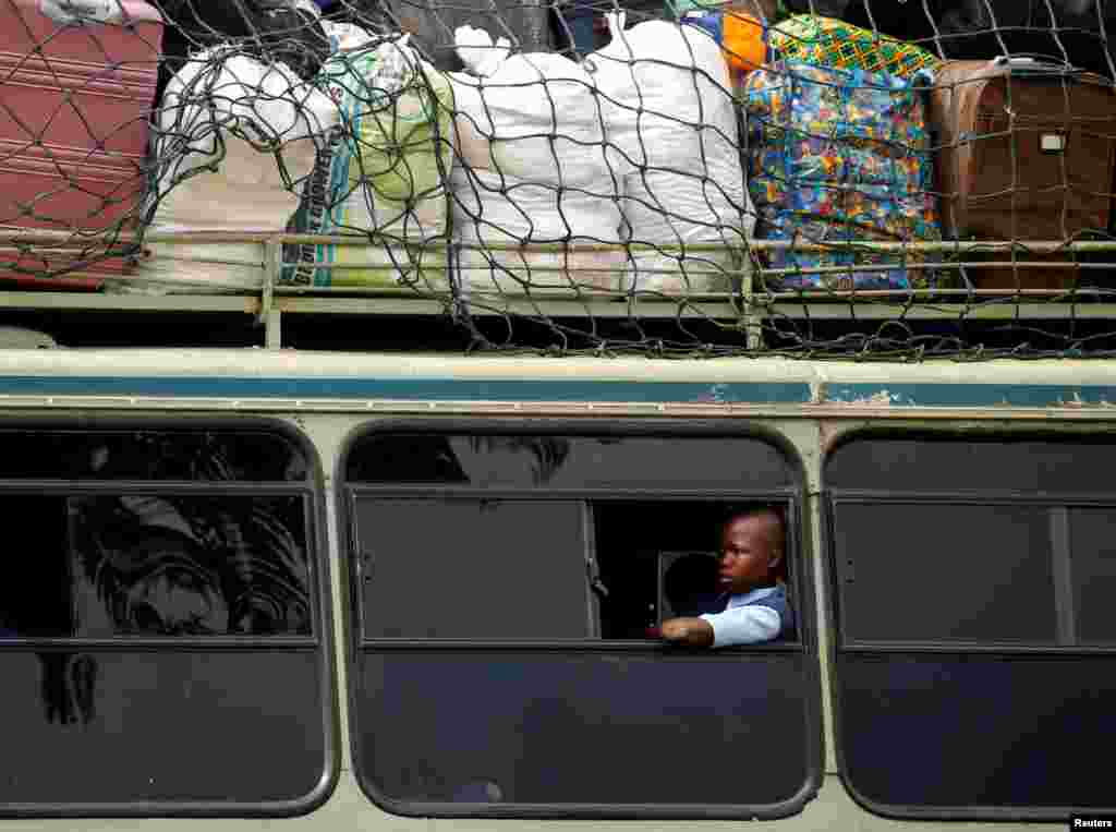 A child sits inside a bus heading to a boarding school for the opening day of the new school term, in Mbare township, Harare, Zimbabwe.