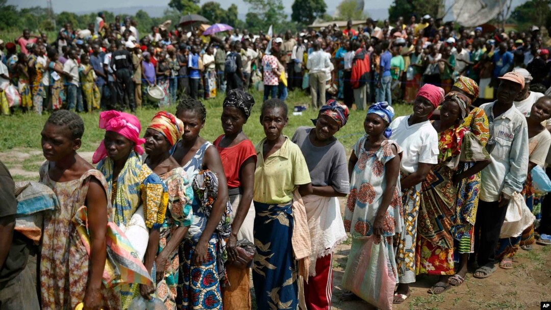 Internally displaced people wait for rations at a World Food Program distribution point near a makeshift camp set up in Bangui, Central African Republic, Dec. 13, 2013.
