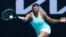 FILE: Venus Williams makes a forehand return to Belgium's Kirsten Flipkens during their first round match at the Australian Open tennis championship in Melbourne, Australia, on Feb. 8, 2021.