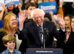 FILE - Democratic presidential candidate Senator Bernie Sanders is accompanied by his wife, Jane O’Meara Sanders, and other relatives as he speaks at his New Hampshire primary night rally in Manchester, Feb. 11, 2020.