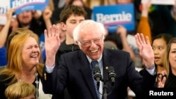 Democratic U.S. presidential candidate Senator Bernie Sanders is accompanied by his wife Jane O’Meara Sanders and other relatives as he speaks at his New Hampshire primary night rally in Manchester