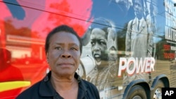 FILE - Carol Blackmon, Mississippi organizer for Black Voters Matter, stands by the organization's bus outside a voting precinct in Jackson, Miss., on November 7, 2023.