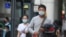People wear face masks to protect against the coronavirus, in Taipei, Taiwan, Feb. 26, 2020. 