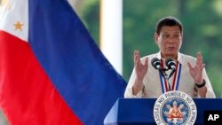 FILE - Philippine President Rodrigo Duterte gestures while speaking following a wreath-laying ceremony in observance of National Heroes Day, Aug. 29, 2016 at the Heroes Cemetery in suburban Taguig city, east of Manila.