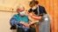 88 year old Trevor Cowlett receives the Oxford University/AstraZeneca COVID-19 vaccine from nurse Sam Foster at the Churchill Hospital in Oxford, southwest England on January 4, 2021. - Britain today began the mass rollout of the Oxford-AstraZeneca corona