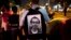 Egyptian activist with poster of slain activist Mohammed el-Gendy, who was killed during the Arab Spring uprising, at rally to withdraw confidence from Egyptian President Mohamed Morsi, Cairo, May 16, 2013.