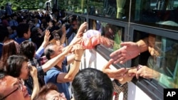 FILE — North Koreans on a bus say goodbye to their South Korean relatives after the Separated Family Reunion Meeting in North Korea, Aug. 26, 2018. The U.S. Congress did not pass a bill that would have reunited Korean Americans with their families in North Korea.