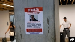 A wanted poster of Venezuela's opposition leader Edmundo Gonzalez covers a column at the Simon Bolivar International Airport in Maiquetia, near Caracas, Venezuela, Jan. 3, 2025. 