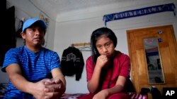 Manuel Marcelino Tzah, left, and his daughter Manuela Adriana, 11, sit inside their apartment during an interview hours after her release from immigrant detention, Wednesday July 18, 2018, in Brooklyn borough of New York. The Guatemalan asylum seekers were separated May 15 after they crossed the U.S. border in Texas.