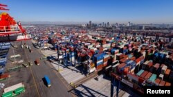 FILE - Automated electric trucks transport shipping container at the Long Beach Container Terminal in Long Beach, California, U.S., February 9, 2023. (REUTERS/Mike Blake)